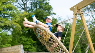 Heligan Play Meadow Kids On Swing
